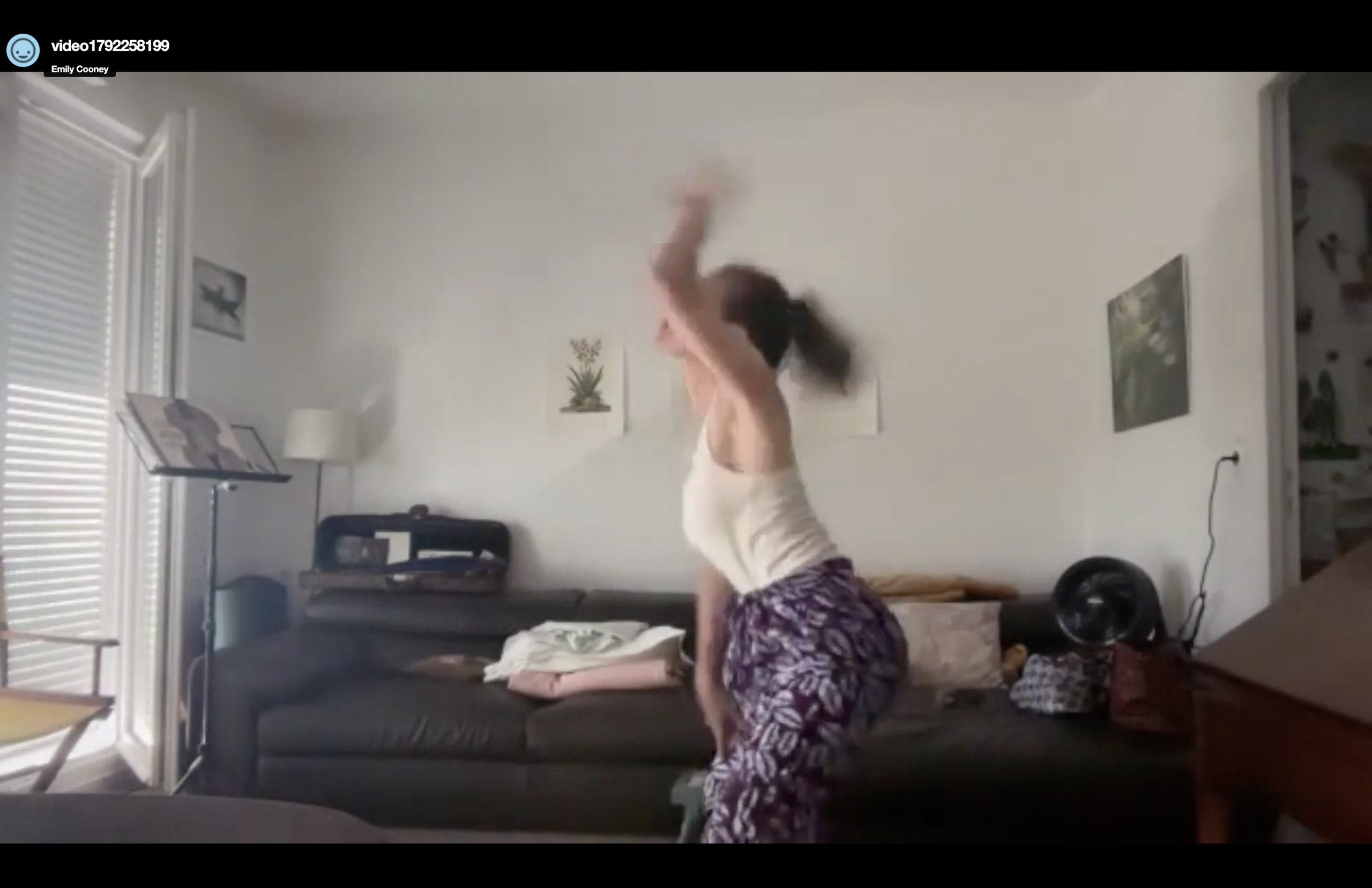 woman dancing wildly in her living room